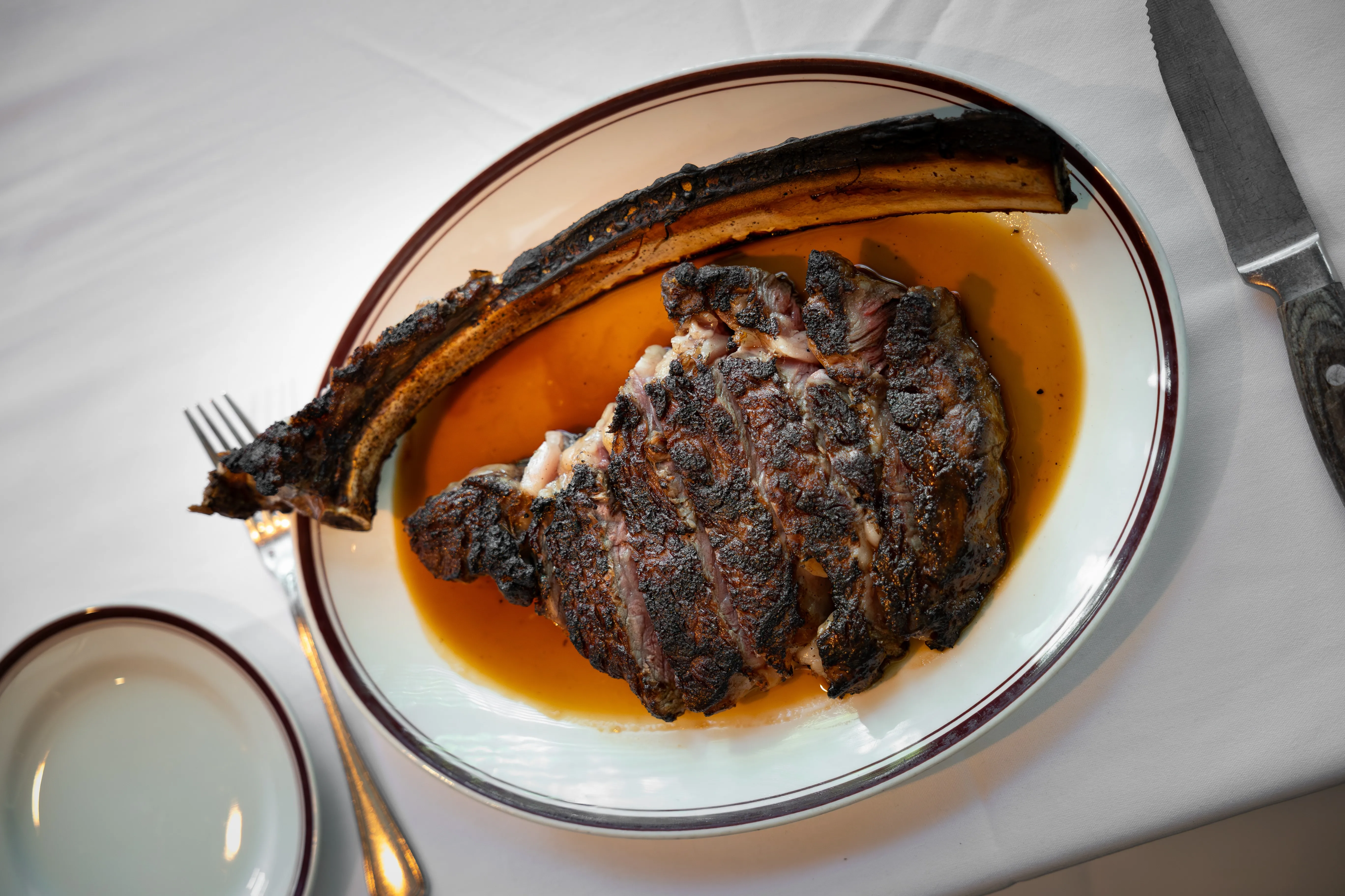 Tomahawk Steak, sliced and plated, at Chops Lobster Bar, Boca Raton