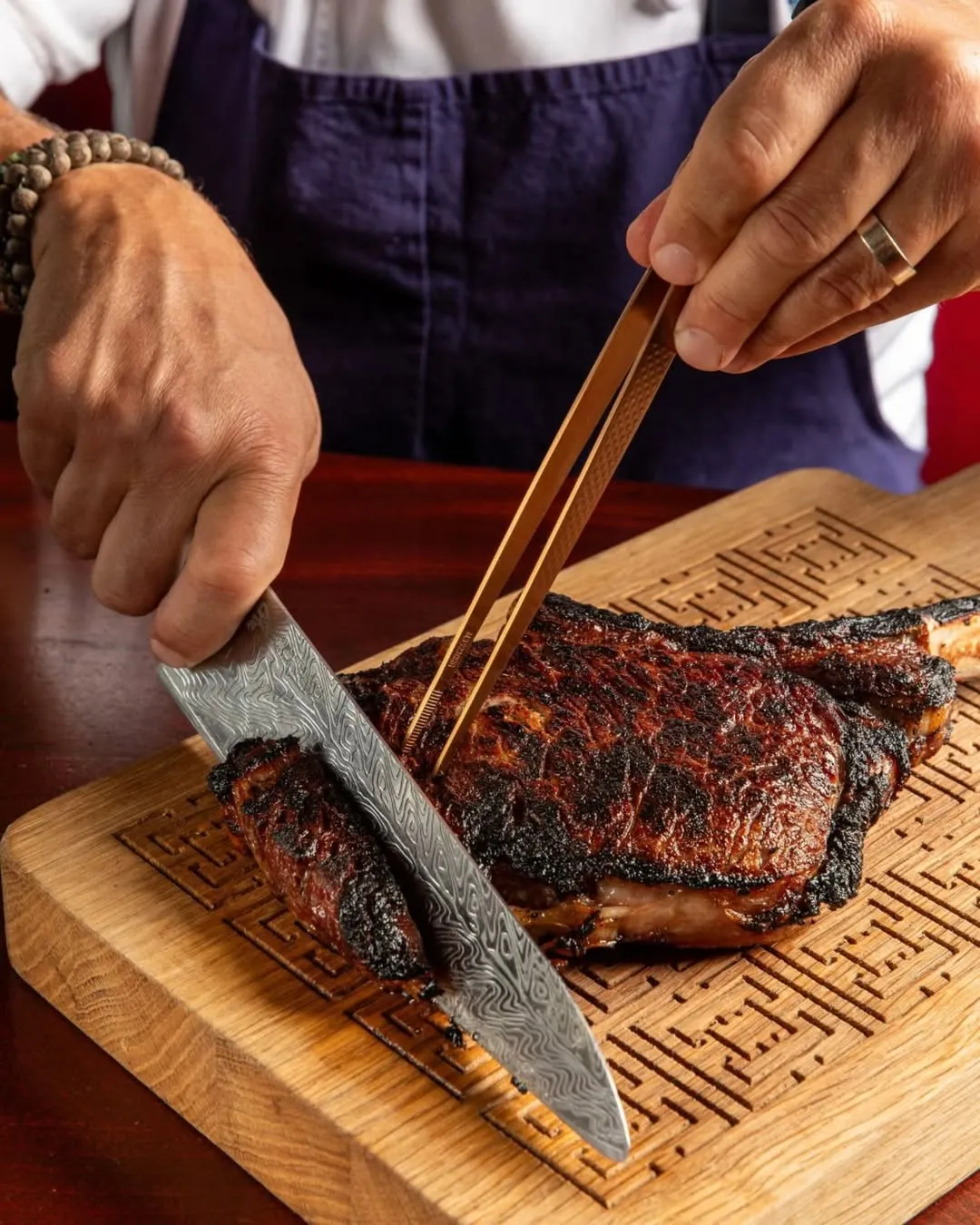 Prime steak being carved tableside at Chops Lobster Bar