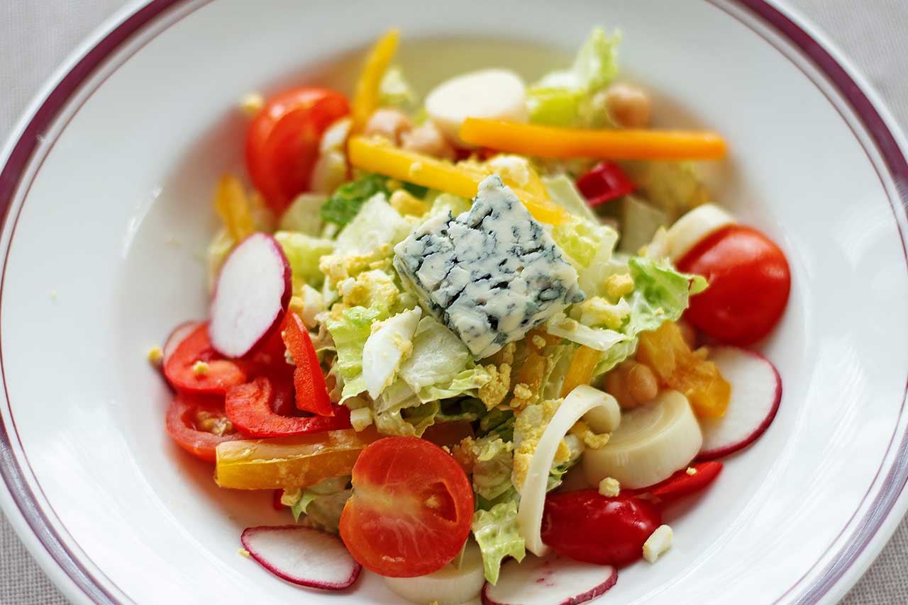Salad with tomoato, raddish, carrot, blue cheese and more